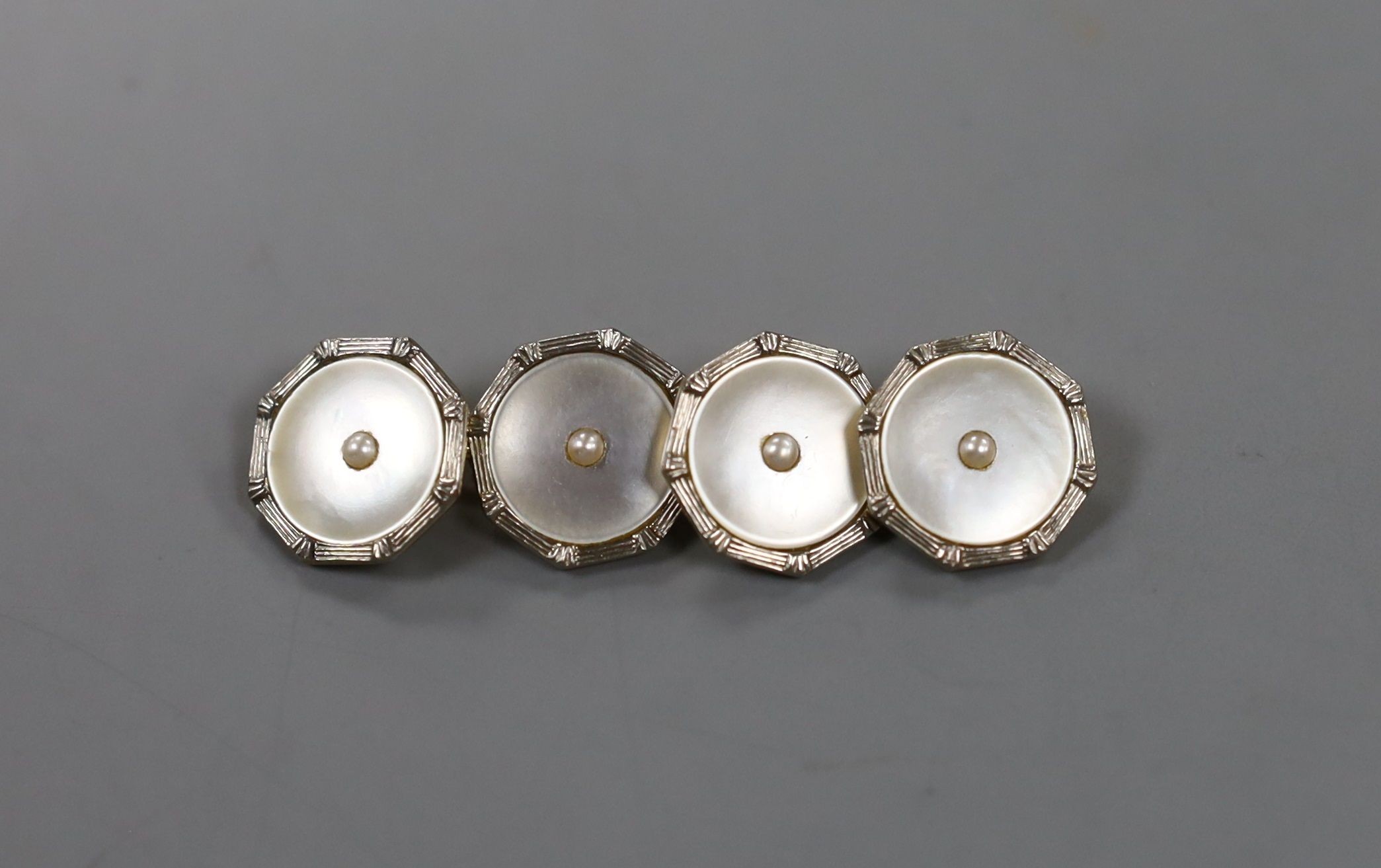 A cased pair of 18ct, 9ct, mother of pear and seed pearl set circular cufflinks, 13mm, gross weight 4.8 grams.